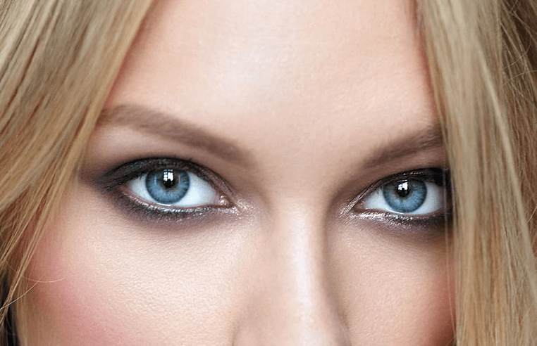 A Woman wears blue colored contacts